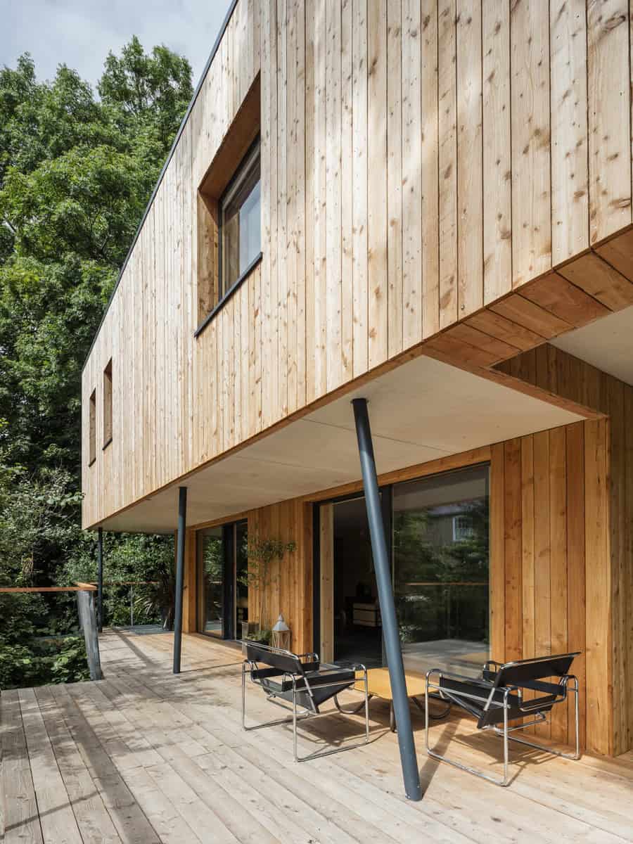 Dursley Treehouse elevated timber deck veranda with Wassily chairs and cantilevered upper storey